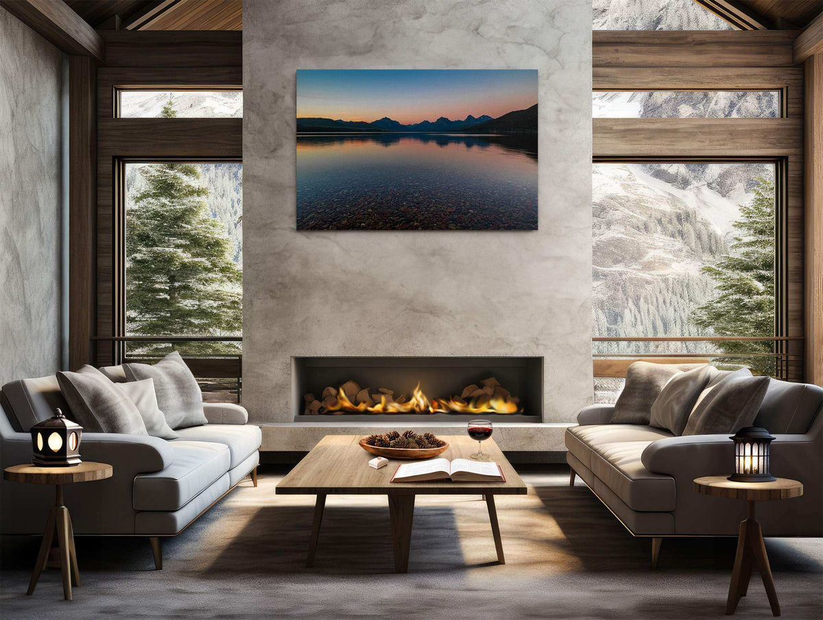Glacier National Park Print showing a calm lake reflecting mountain silhouettes beneath a warm orange and blue sunset sky