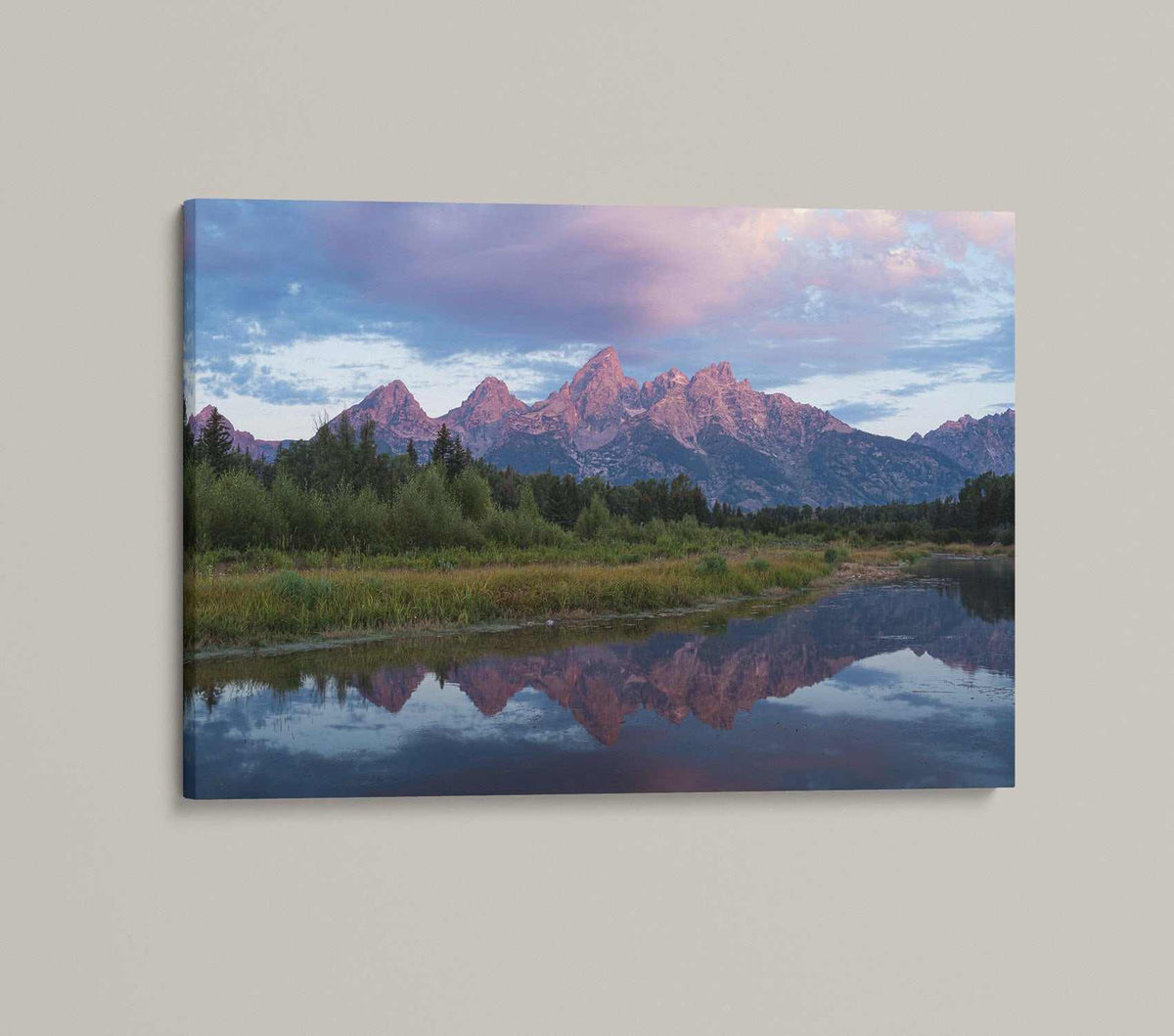 Grand Teton Sunrise Print featuring pink-lit mountain peaks, blue and lavender sky, green shoreline, and calm water reflections