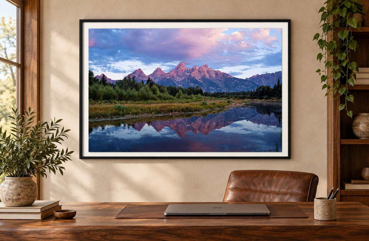 Grand Teton Sunrise Print showing pink mountain peaks reflected in calm water beneath a blue and pink sky, in a black frame
