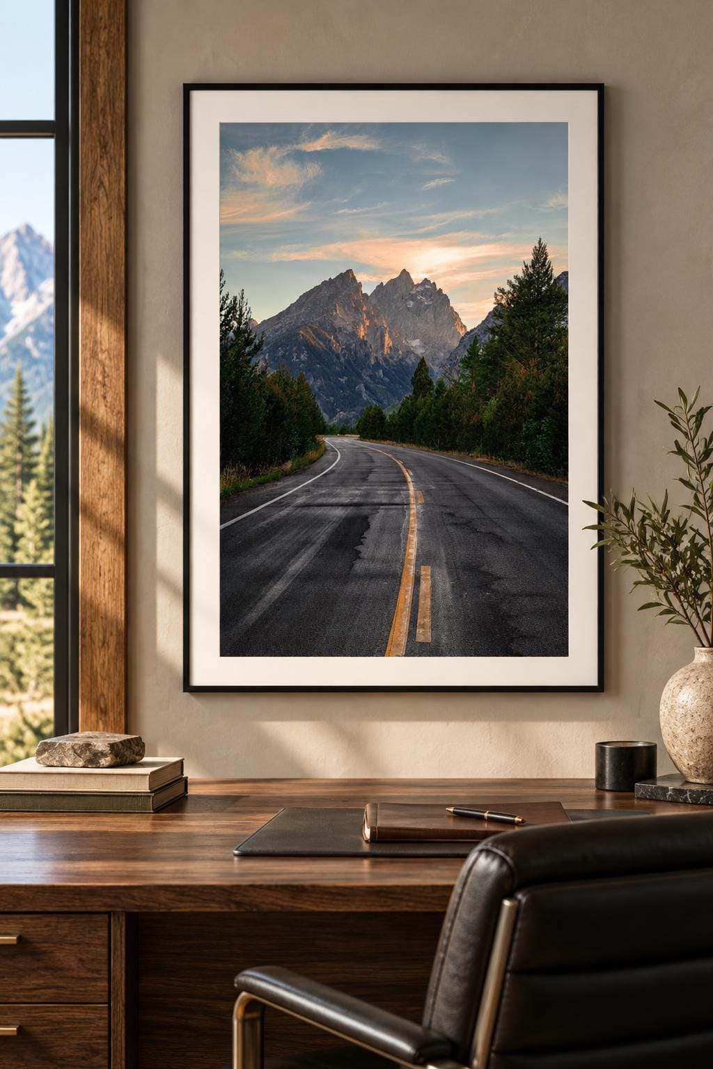 Grand Teton Wall Art featuring a framed color photograph of a winding road leading toward rugged mountains beneath a pastel sky