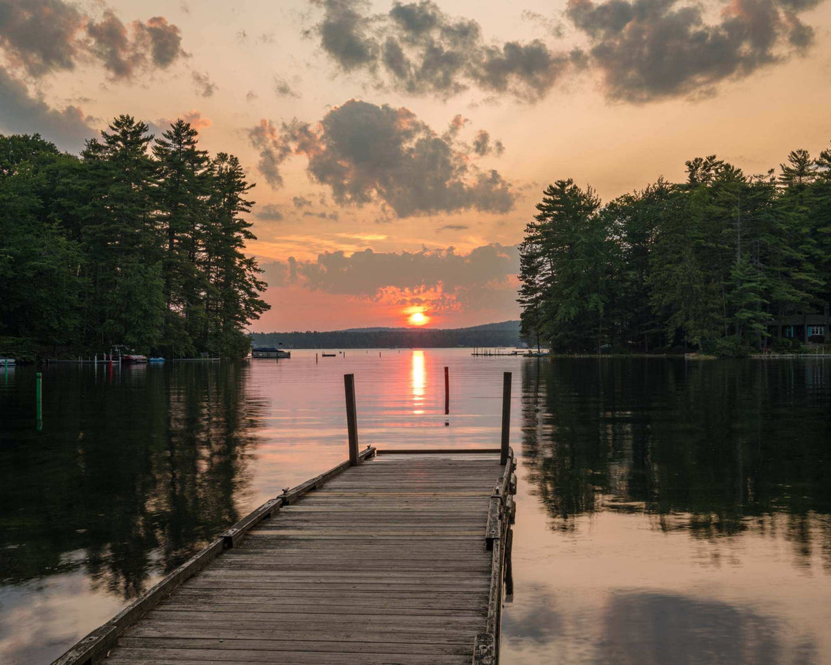 Great East Lake Dock Sunset Print showing a wooden dock over calm water, evergreen shoreline, and orange sunset sky