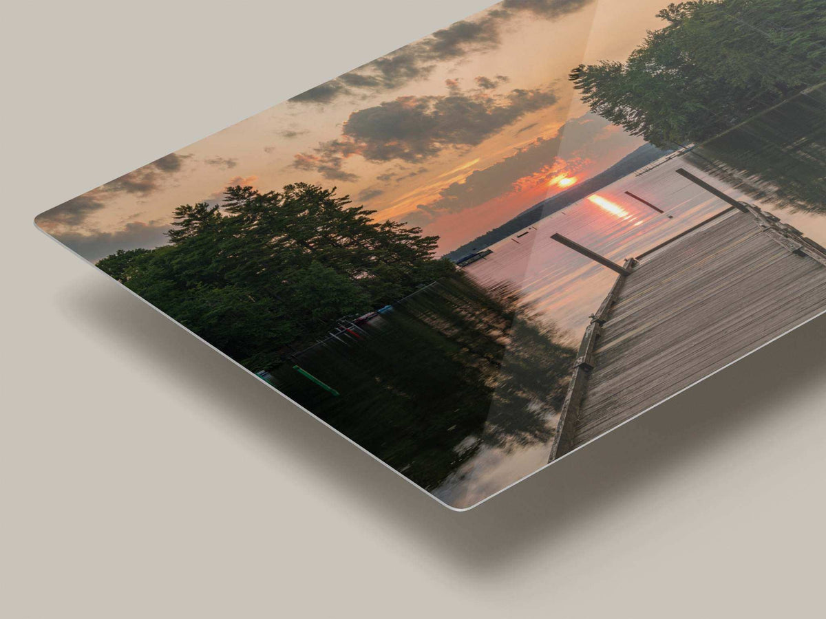 Great East Lake Dock Sunset Print, vivid landscape print with a wooden dock, tree-lined shore, and orange sunset reflected on water