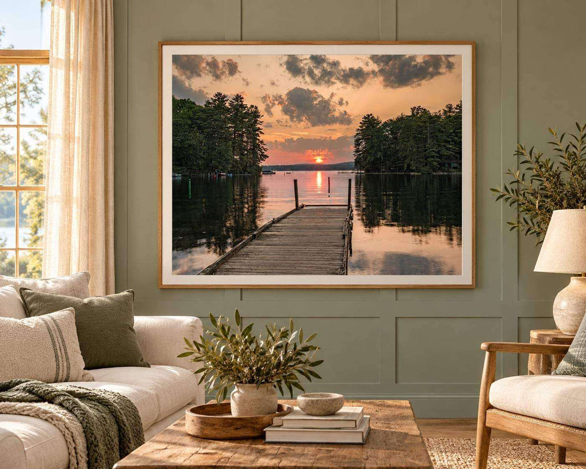 Great East Lake Dock Sunset Print showing a weathered wooden dock over calm water, dark tree-lined shores, and a peach sunset sky