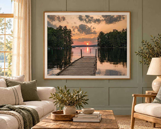 Great East Lake Dock Sunset Print showing a weathered wooden dock over calm water, dark tree-lined shores, and a peach sunset sky