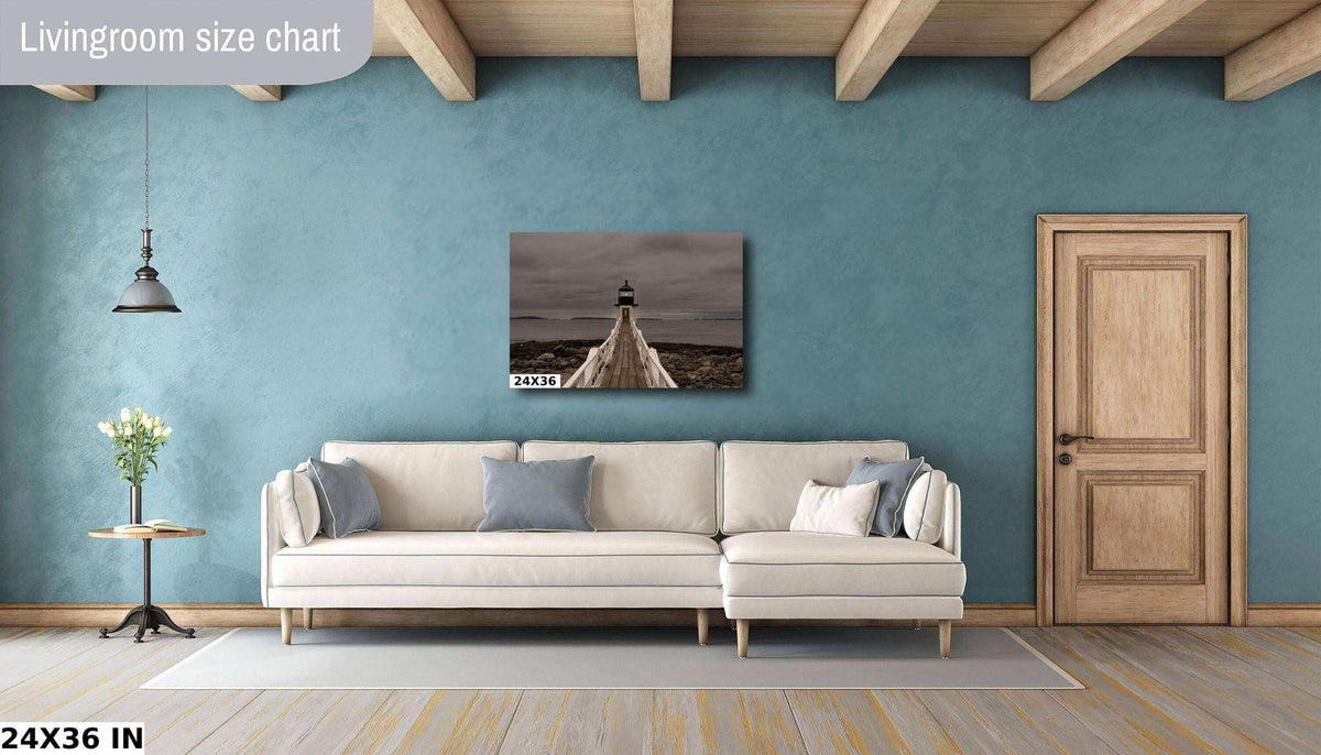 Marshall Point Lighthouse Print showing a small lighthouse at the end of a rocky coastal walkway beneath a dark, cloudy sky