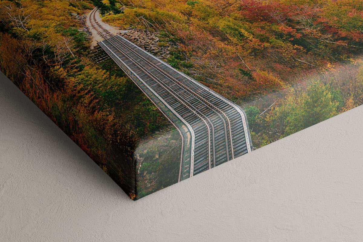New Hampshire Fall Foliage Print on canvas, showing curving railroad tracks amid dense orange, red, and green autumn trees