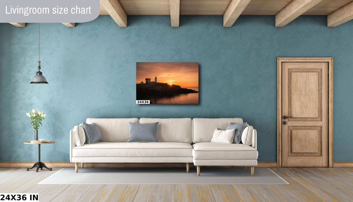 Nubble Lighthouse Print showing a coastal lighthouse silhouetted against an orange sunrise over the water