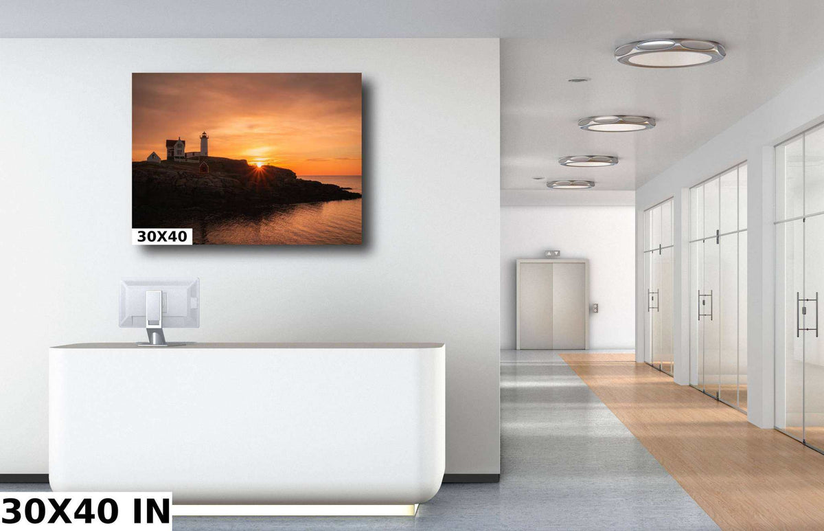 Nubble Lighthouse Print showing a coastal photograph of the lighthouse on a rocky shore at sunset, with orange skies and calm water