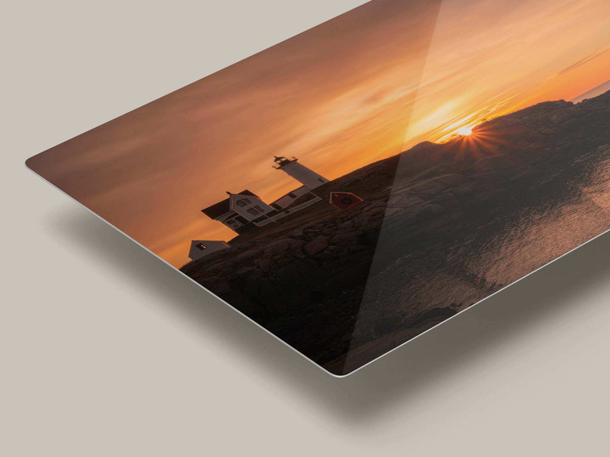 Nubble Lighthouse Print, vivid orange sunrise coastal photograph on glossy metal, with lighthouse and rocky shore