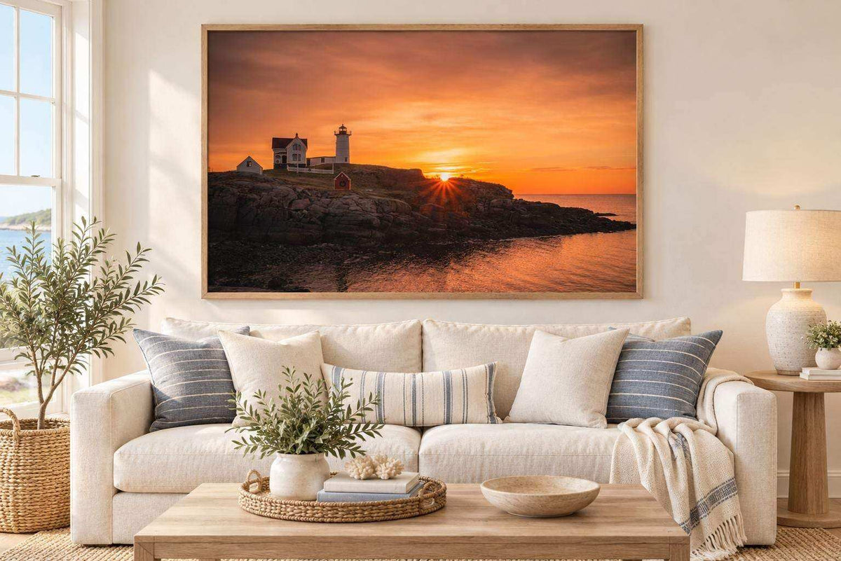 Nubble Lighthouse Print featuring a lighthouse on a rocky Maine coast in vivid orange and pink sunrise tones