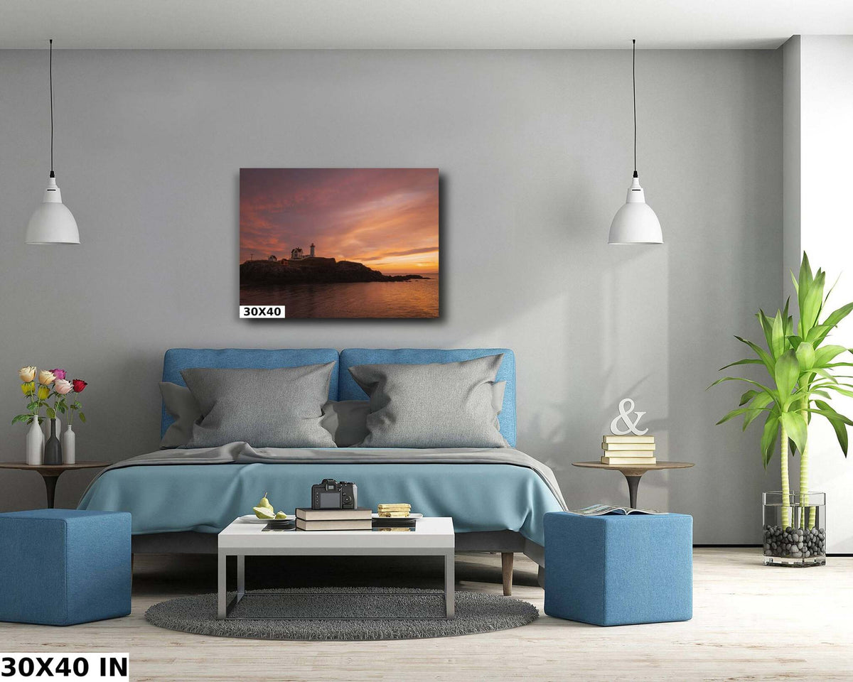 Nubble Lighthouse Wall Art with a dark coastal lighthouse silhouette against a vivid orange and magenta sunset over water