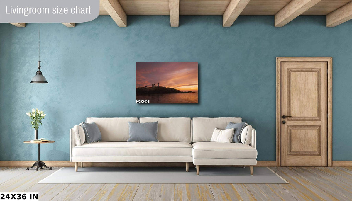 Nubble Lighthouse Wall Art displays a coastal sunset print with a small lighthouse silhouette in orange and pink tones