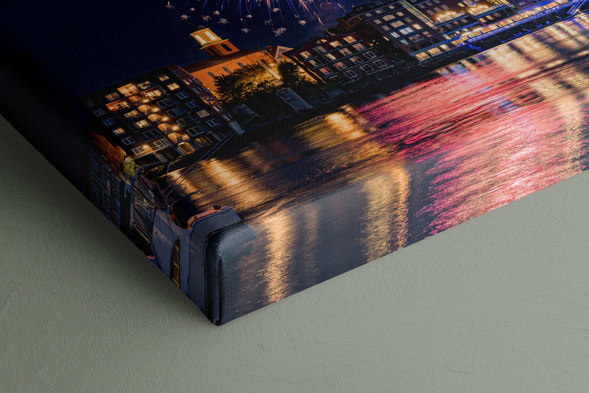 Portsmouth NH Fireworks Print featuring colorful bursts reflected across harbor water beside waterfront buildings, printed on canvas