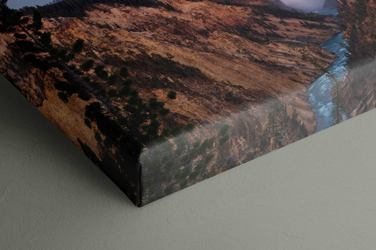 Yellowstone Lower Falls Print on a canvas wrap, showing a blue waterfall winding through a rugged rust-brown canyon.