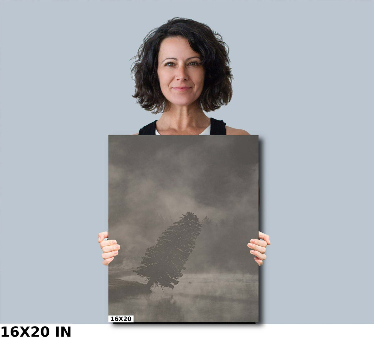 Yellowstone National Park Print with a dark leaning tree in a muted gray foggy landscape, shown on a rectangular print